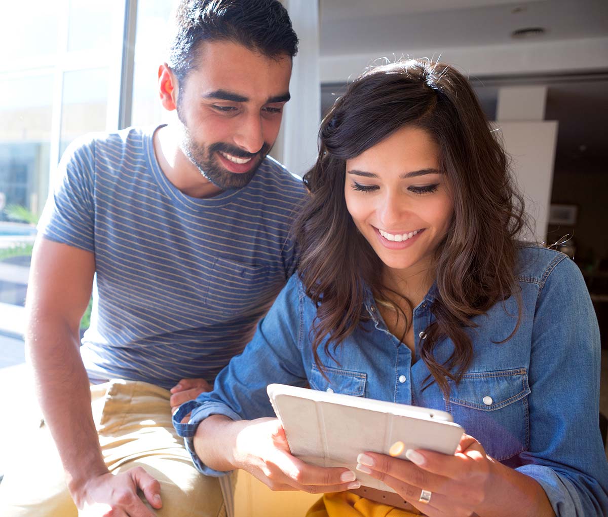 Couple using a tablet to look at their online home inspection report